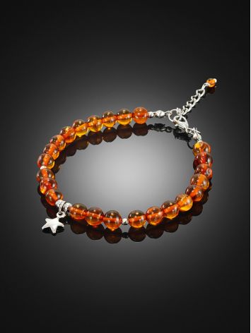 Delicate bracelet made of natural cognac amber with a star-shaped pendant, image , picture 2